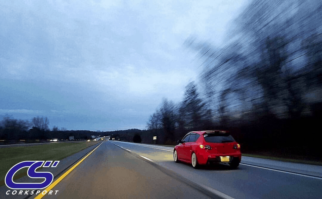 Mazda driving down a road.