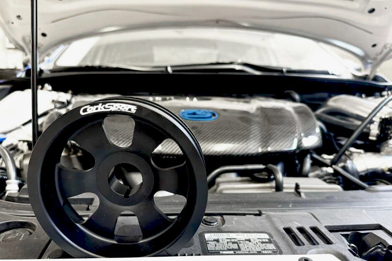 An overhead view of CorkSport's crank pully for 2014 Mazda 3 in the engine bay.